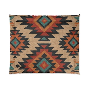 May include: A square comforter with a Southwestern geometric pattern. The design features repeating shapes in black, orange, teal, and tan. The comforter has a textured appearance, suggesting a woven fabric. The overall aesthetic is rustic and decorative.