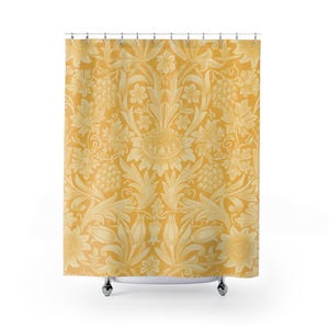 May include: A yellow shower curtain with a repeating floral pattern. The design features large sunflowers, grape clusters, and stylized leaves in a lighter shade of yellow. The curtain hangs from silver metal rings.
