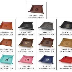 May include: A collection of personalized leather valet trays in various colors, including brown, black, gray, teal, pink, and red. Each tray features custom engraving, with options like initials, names, or symbols. The trays are ideal for organizing small items.