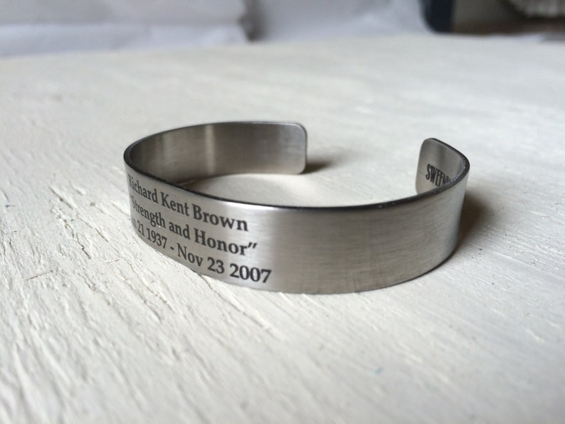 May include: Silver metal bracelet with an engraved message: "Richard Kent Brown Strength and Honor" 02 1937 - Nov 23 2007.