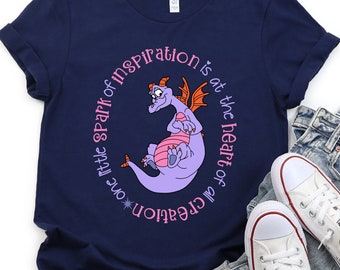 May include: A navy blue t-shirt with a purple dragon and the text "*one little spark of inspiration is at the heart of all creation" printed on the front.
