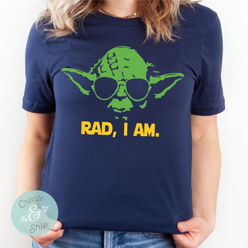 May include: A navy blue t-shirt with a green Yoda character wearing sunglasses and the text "RAD, I AM."