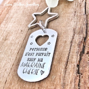 May include: Silver keychain with a star charm and a tag that says "Personne n'est parfait sauf ma Makraine Cherie" with a heart.