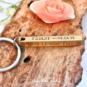 May include: Gold bar keyring with the text "Best Husband Ever" and the dates "23.06.17" and "02.04.18" engraved on it.