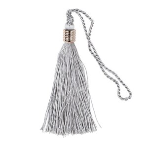 May include: A silver tassel with a gold ring at the top. The tassel is attached to a silver cord.