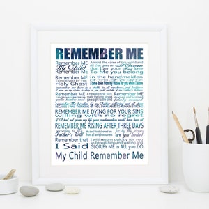 May include: A white framed print with a blue and green gradient background featuring the text "Remember Me" in a large font. The text is surrounded by smaller text in a similar gradient, including phrases like "My Child", "Holy Ghost", and "I Said".