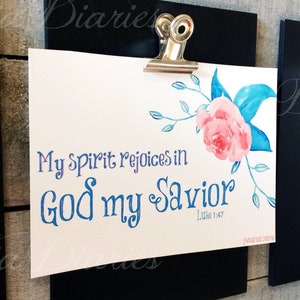 May include: A white card with a watercolor floral design and the text "My Spirit rejoices in God my Savior Luke 1:47" printed in blue and pink.