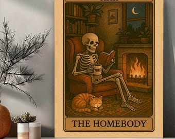 May include: A framed print featuring a skeleton reading a book in a cozy setting. The skeleton is seated in a chair with a cat sleeping nearby. The print has a vintage aesthetic with the text "XXII" and "THE HOMEBODY".