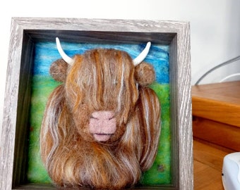 Needle felted highland cow picture.