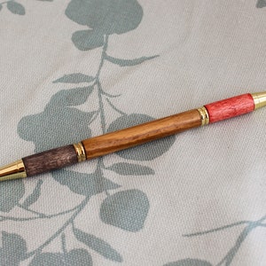 Un stylo à bille bicolore pour étudiant ou enseignant avec un corps tourné à la main en orme anglais, avec des raccords en or poli.