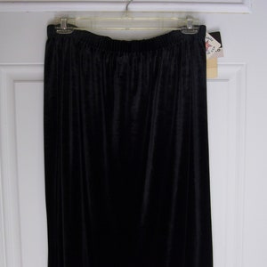 May include: A black velvet skirt with a waistband and a tag that says "Free People".