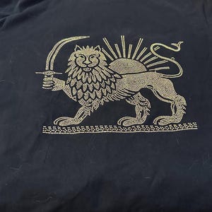 Black T-shirt featuring a gold rhinestone Lion & Sun design — a timeless symbol of Iranian heritage, strength, and pride