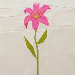 May include: A close-up of a fabric flower with a pink blossom and green stem and leaves. The flower has yellow embroidered details in the center. The background is white with geometric shapes.