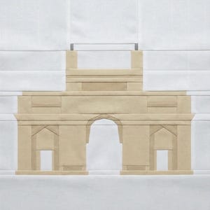 May include: A tan and white fabric art piece depicting a detailed architectural structure with an arched entrance and rectangular pillars. The artwork is set against a white background, showcasing the building's design.