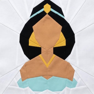 May include: A geometric quilt block featuring a stylized portrait of a woman with black hair, tan skin, and a light blue top. The design incorporates yellow and light blue accents, set against a white background.