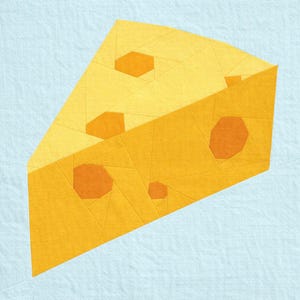 May include: A geometric quilt block showing a wedge of cheese. The cheese is mainly yellow with orange accents for the holes. The block is set against a light blue background, creating a striking contrast.