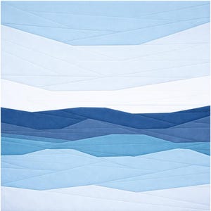 May include: A white ceramic mug with a black handle and the text "But First, Coffee" in a bold, black font. The mug is set against a blurred background, suggesting a cosy setting.