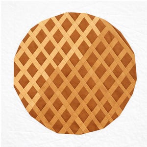 May include: A circular, brown and tan quilted design with a lattice pattern. The design is set against a white background. The lattice pattern is made of tan strips over a brown base, creating a grid-like appearance. The overall shape is round, resembling a pie.
