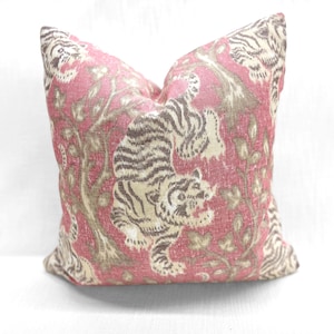 May include: A red and cream throw pillow with a tiger print design. The pillow features a large tiger in the center with a floral pattern in the background.