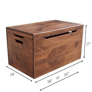 May include: A wooden toy chest with a dark brown finish. The chest is rectangular, with dimensions of 36 or 30 inches long, 18 inches wide, and 17 inches high. It features built-in handles and a hinged lid.