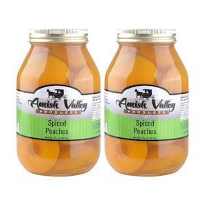 May include: Two glass jars of Amish Valley Spiced Peaches. Each jar contains sliced peaches in a clear syrup. The jars have gold lids and labels with the company name and product description. Net weight is 32 oz (907g).