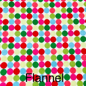 May include: A white fabric with a repeating pattern of colorful polka dots in red, pink, green, blue, and yellow. The word "Flannel" is printed in black at the bottom of the image. This fabric is suitable for various sewing projects.