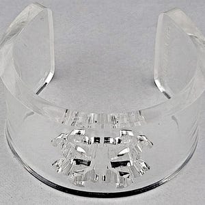 May include: A handmade, wooden serving tray with a natural finish. The tray features a rectangular shape with raised edges and integrated handles. The wood grain is visible, showcasing the tray's rustic charm. Dimensions: 18 inches long, 12 inches wide, and 2 inches high.