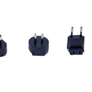 May include: Four black electrical plug adapters with different prongs. The adapters are designed to convert plugs from one country to another.