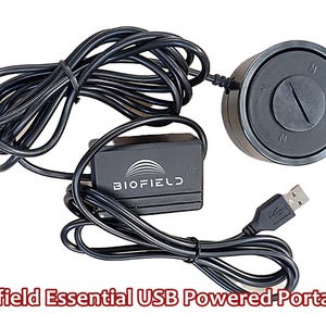 May include: A black Biofield Essential USB Powered Portable device. The image shows a round component with N and S markings, a small rectangular component with the Biofield logo, and a USB connector. All components are connected by black cables.