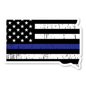 May include: A distressed American flag with a thin blue line running horizontally across the middle, shaped like the state of South Dakota.