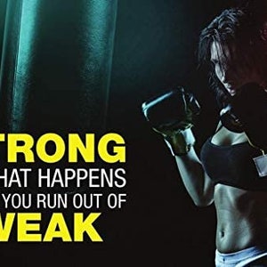 May include: A motivational poster featuring a woman wearing boxing gloves and a black sports bra. The text on the poster reads "STRONG IS WHAT HAPPENS WHEN YOU RUN OUT OF WEAK".