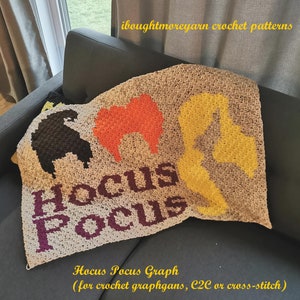 May include: A crochet blanket with the words "Hocus Pocus" in purple yarn and the Sanderson sisters from the movie Hocus Pocus in black, orange, and yellow yarn. The caption reads "Hocus Pocus Graph (for crochet graphgans, C2C or cross-stitch)".