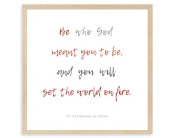 May include: A beige framed print with a quote in red and gray text: "Be who god meant you to be. and you will set the world on fire." The quote is attributed to St. Catherine of Siena.