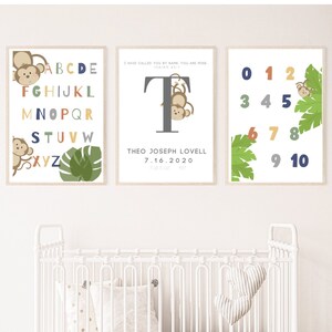 May include: Three framed prints with a jungle theme. The first print features the alphabet with colourful letters and monkeys. The second print features the letter T with a monkey hanging from it and the text "I have called you by name, you are mine. Isaiah 43:1."  The third print features numbers 0-10 with monkeys and green leaves.