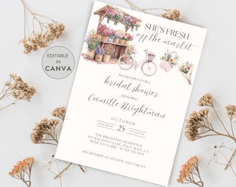 May include: A watercolour illustration of a flower market with a bicycle and a pink bag. The text "She's Fresh off the Market" is at the top of the invitation. The invitation is for a bridal shower for Camille Brightman on 25th October at 2:00 PM. The event will be held at The Brightman Residence, 555 Magnolia Lane, Palo Alto, CA. RSVP to Claire at 555 555 5555. The invitation also states that the event is registered at Amazon and Target.