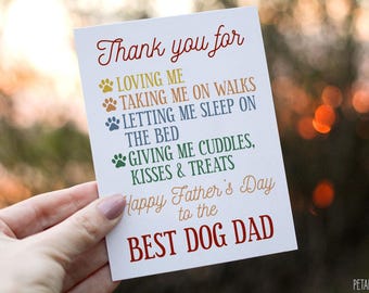 May include: A white card with colorful paw prints and the text "Thank you for LOVING ME TAKING ME ON WALKS LETTING ME SLEEP ON THE BED GIVING ME CUDDLES, KISSES & TREATS Happy Father's Day to the BEST DOG DAD".