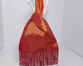Blood orange with red stripe knot bag with fringe