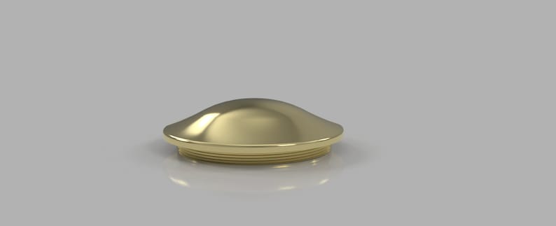 May include: A gold-colored metal cap with a rounded top and a slightly flared base. The cap has a smooth, polished finish.