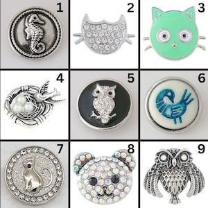 May include: Nine decorative snap buttons with various designs. The designs include a seahorse, an owl shape with rhinestones, a green cat face, a bird in a nest with pearls, an owl on a black background, a blue bird, a cat, a bear, and a detailed owl.