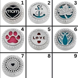May include: A collection of nine silver-colored, round essential oil diffuser lockets. Each locket features a different design, including a heart with the word "mom", an anchor, a leaf, a paw print, the word "LOVE", angel wings, and a heart-shaped pattern.