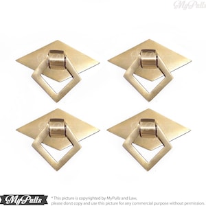 May include: Four gold-toned cabinet pulls with a diamond-shaped base and a square ring handle.