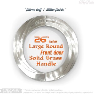 May include: A 26 inch silver door handle with a matte finish. The handle is round and made of solid brass. The text "Silver doff / Matte finish" and "26 inches Large Round Front door Solid Brass Handle" is visible in the image.