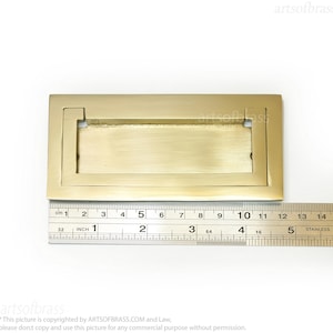 Polished gold solid brass rectangular flush door handle close up