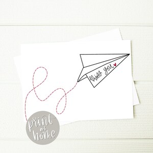 May include: Printable card featuring a black and white paper aeroplane illustration with a red heart and the text "miss you". A red dashed line trails behind the aeroplane.