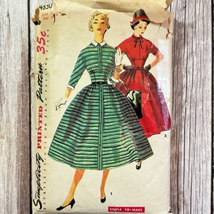May include: Vintage Simplicity sewing pattern for a dress. The pattern is for a striped dress with a collar and buttons. The pattern is printed on a yellowed paper with the text "Simplicity Printed Pattern 4830 35c".