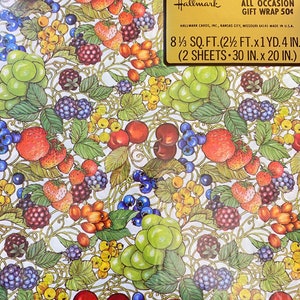 May include: A sheet of Hallmark gift wrap featuring a colorful pattern of various fruits, including strawberries, cherries, grapes, and blackberries. The wrap is designed for all occasions and measures 8 1/3 square feet (2 1/2 feet by 1 yard, 4 inches). It includes two sheets, each measuring 30 inches by 20 inches.