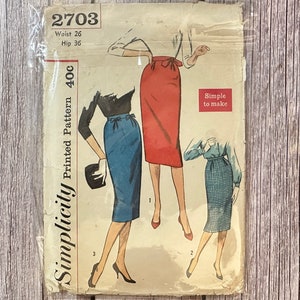 May include: Vintage Simplicity sewing pattern for a skirt, pattern number 2703, size 26 waist, 36 hip. The pattern is for a printed skirt and includes three different styles. The pattern is labelled "Simple to make".