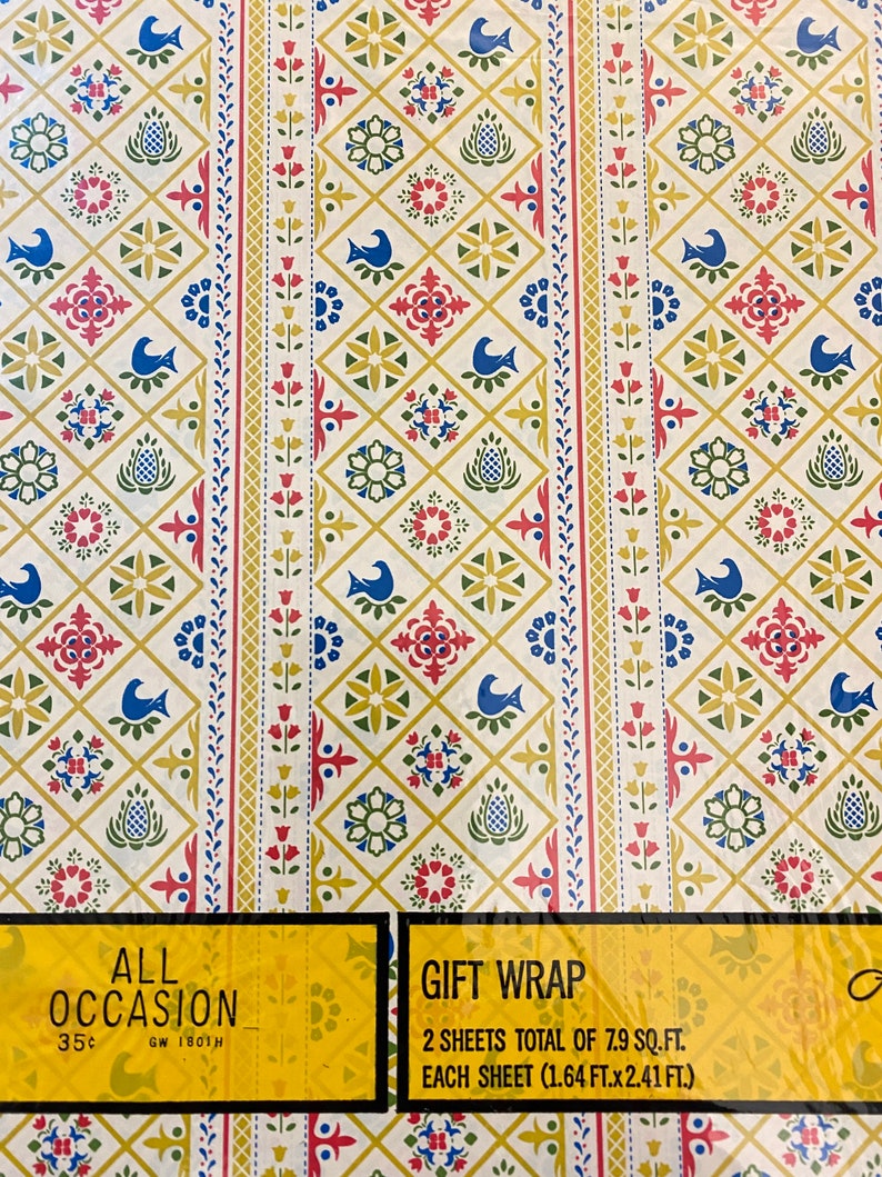May include: Two sheets of yellow, red, blue, and green patterned gift wrap. The wrap has a geometric design with flowers and birds. The text on the package reads "All Occasion Gift Wrap 2 sheets total of 7.9 sq. ft. Each sheet (1.64 ft. x 2.41 ft.) 35&cent; GW 1801H"