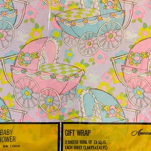 May include: A sheet of baby shower gift wrap featuring a pink and blue baby carriage design on a light purple background. The text on the sheet reads "Baby Shower" and "Gift Wrap". The dimensions of the sheet are also included: "2 sheets total of 7.9 sq. ft. Each sheet (1.64 ft. x 2.41 ft.)".