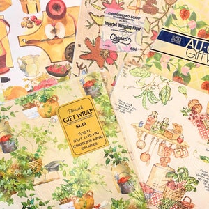 May include: A selection of vintage gift wrap featuring various floral and fruit designs. The wraps are in shades of yellow, green, red, and blue. The text on the wraps reads "Flourish Gift Wrap &pound;1.10 2 Sheets 25 in x 20 in for larger", "All Occasion Gift Wrap 2 Sheets - 8.5 x 11 in (each sheet 17 x 11 in)", and "Red Farm Store Pantucket, RI 02863 2 Sheets Each Sheet 17 x 11 in".